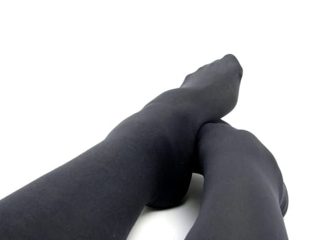 Feet in black opaque silk stockings