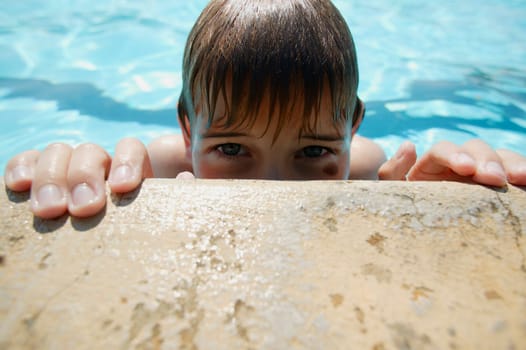 Boy creeps up on side of pool