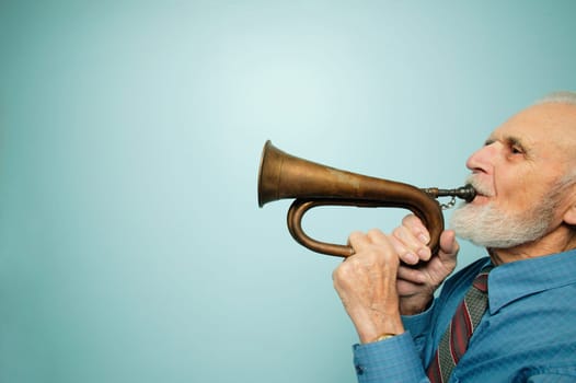 Profile of man playing horn