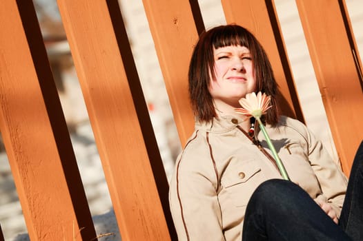 Woman squints at sunlight