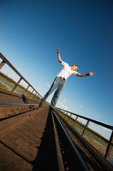 Teen walks on train tracks