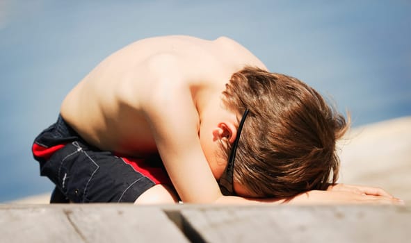 Child lays on the beach