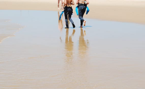 Young surfers walking on the beach
