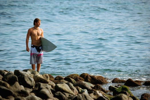 Surfer looking out to sea