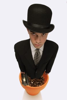 A man wearing a suit standing in a flower pot