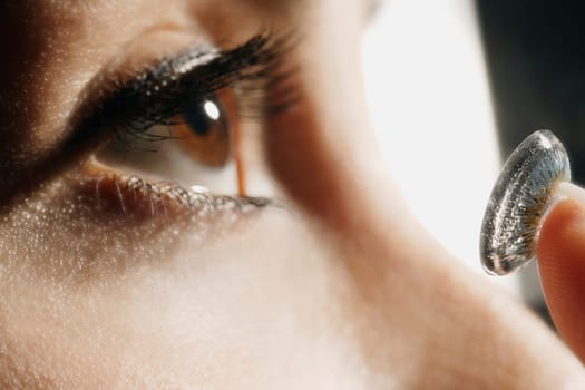 Close-up of woman putting in a contact lens