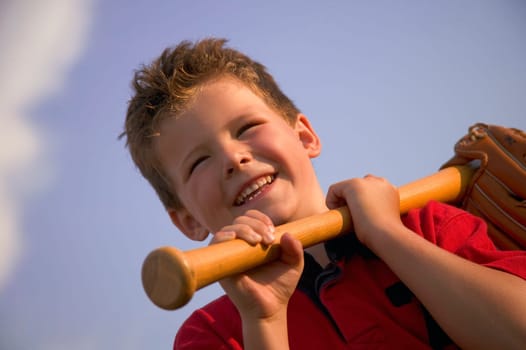 Smiling boy with a baseball bat