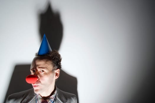 Man wearing clown's nose and hat
