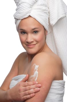 Woman applying lotion on skin