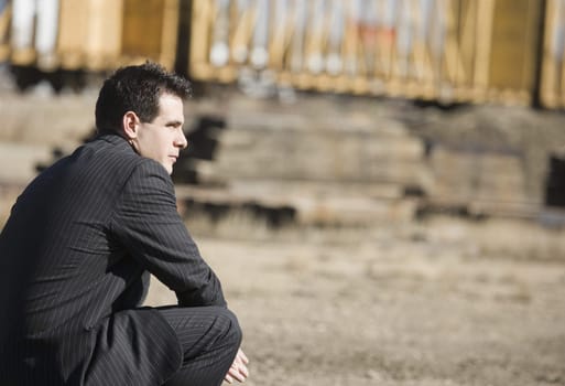 Man in a pinstriped suit bending down