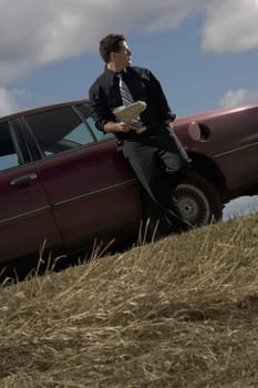 Stranded man standing by car