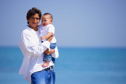 Father and infant on beach