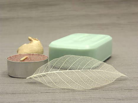 Green soap with decorative items against gray background