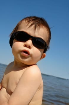 Baby boy by the lake