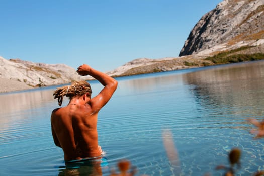Man bathing in mountain lake