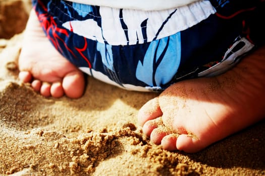 Child sitting in sand