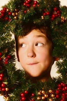 Boy in Christmas wreath