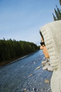 Young woman looking at river