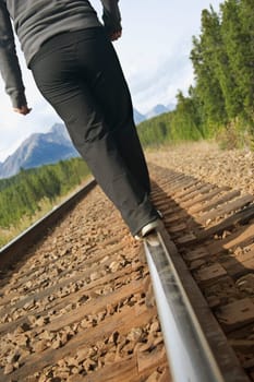 Woman walking on train tracks