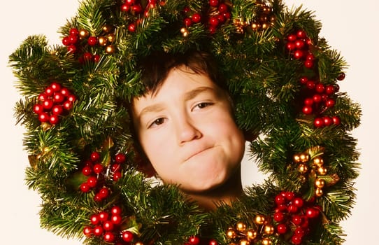 Young boy in Christmas wreath