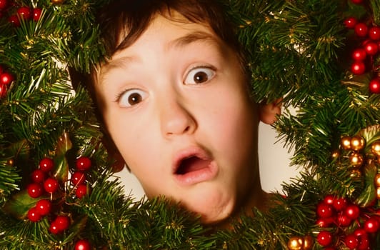 Boy in a Christmas wreath