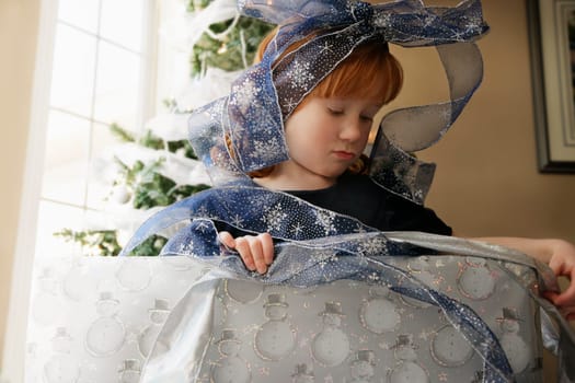 Girl wrapping a Christmas present