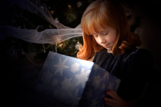 Girl looking inside a Christmas present