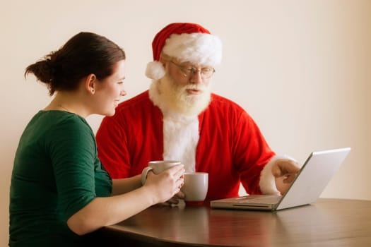 Woman and Santa using a laptop