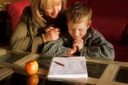 Mother and son praying together
