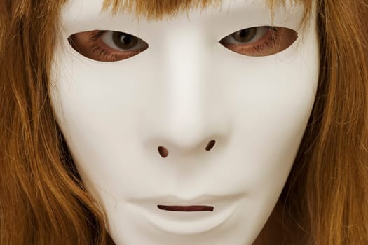 Woman hiding behind mask