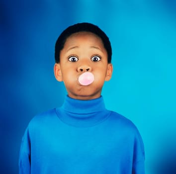 A boy blowing a bubble