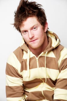 Young adult male posing in fashionable striped sweater