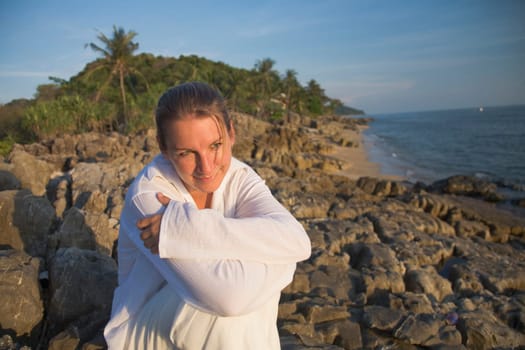 Woman on rocky shoreline
