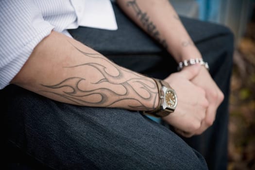 Man with tattooed arms