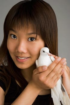 A woman holding a dove