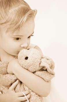 Girl kissing her stuffed animal
