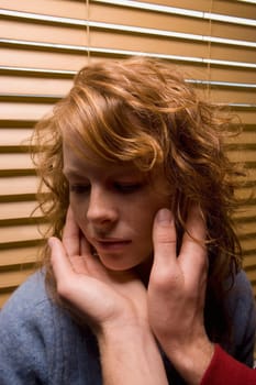 Man's hands touching a woman's face