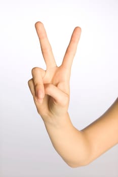 Woman's hand making a peace sign