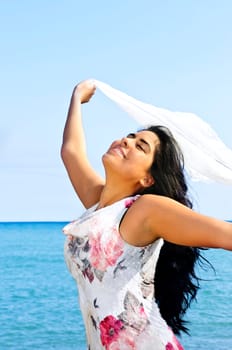 Beautiful young woman at beach with whit