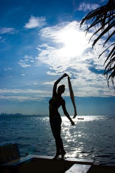 Girl silhouette at the sea