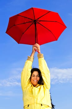 Beautiful young woman in raincoat with u