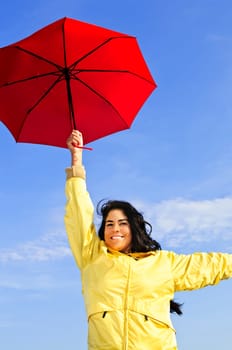 Beautiful young woman in raincoat with u