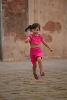 Girl running through street