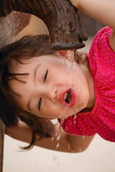 Girl drinking from water fountain