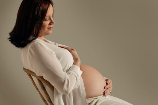 A mother looks at her pregnant belly