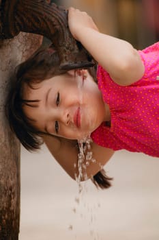 Girl drinking from water fountain