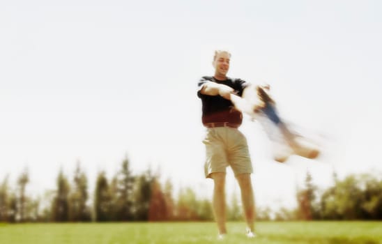 Father swings child around