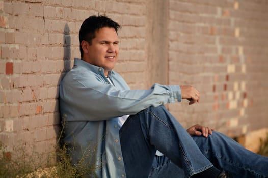Man leans against wall
