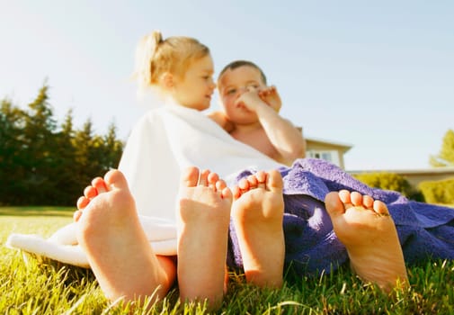 Two kids dry in a towel