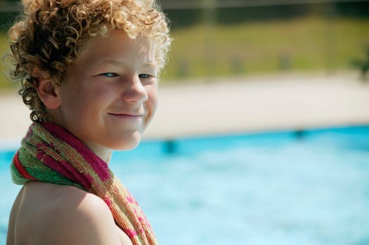 Boy sits beside the pool